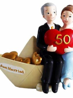 Wedding couple in a boat celebrating 50th anniversary - cake topper